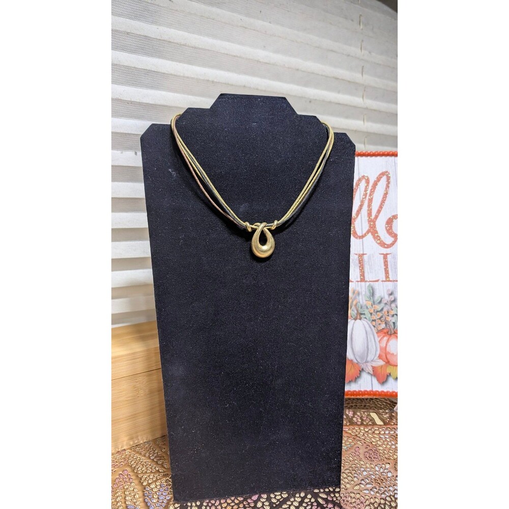 Multi-strand cord necklace with an abstract gold-tone pendant